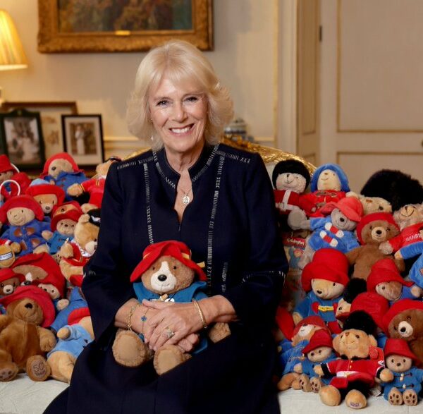 Her Majesty The Queen Consort poses with dozens of Paddington bears as it announced that the sweet tributes to Queen Elizabeth II will be donated to a children's charity
